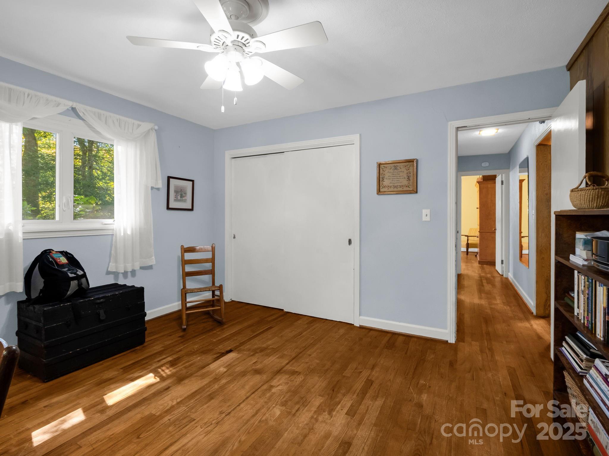821 Warrior Drive Tryon, NC 28782 - Photo 33 of 44 a bedroom with a bed and a chandelier