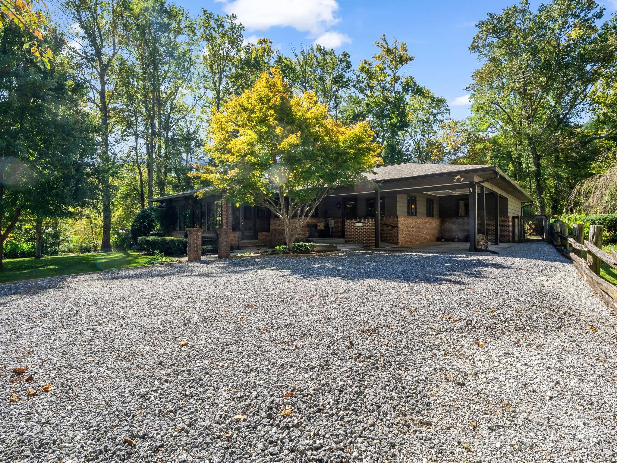 821 Warrior Drive Tryon, NC 28782 - Photo 4 of 44 a front view of a house with a yard
