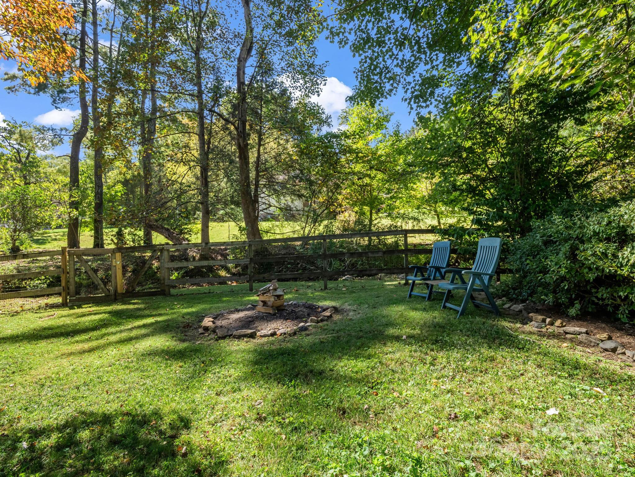 821 Warrior Drive Tryon, NC 28782 - Photo 6 of 44 a backyard of a house with table and chairs