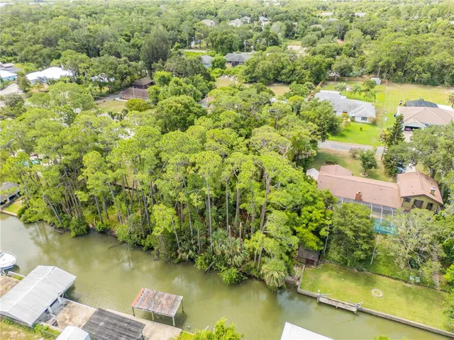 an aerial view of residential houses with outdoor space and swimming pool