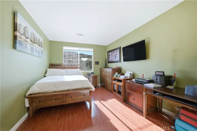 a bedroom with a bed and a flat screen tv