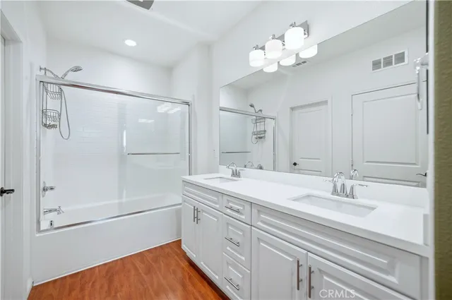 a bathroom with a sink a mirror and a shower