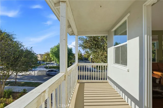 a view of a balcony with wooden floor