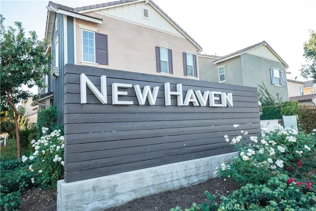 a view of a house with a small yard and flower plants