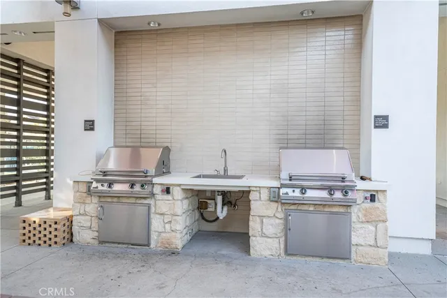 a kitchen with a stove and white cabinets