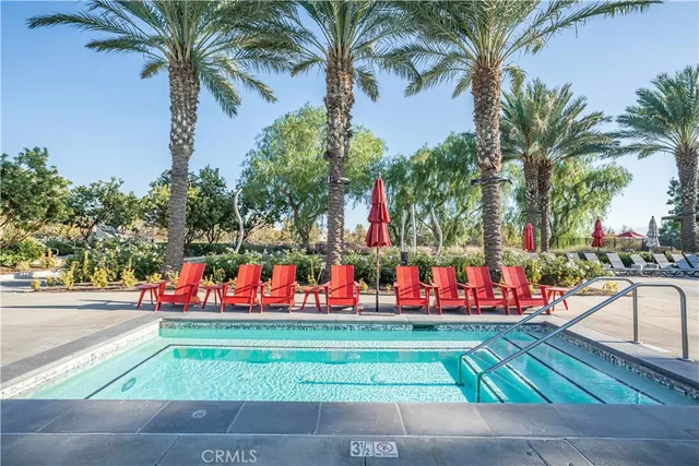 a front view of multi story residential apartment building with sign board and yard