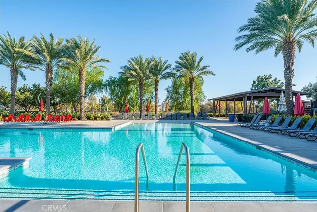 a view of swimming pool with a patio and a garden