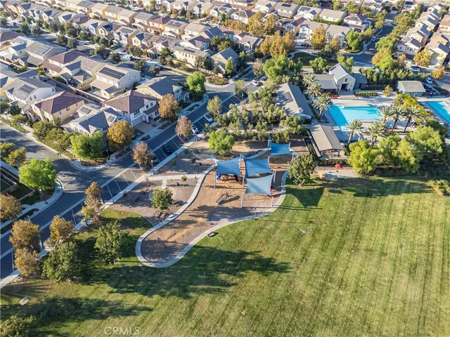 an aerial view of residential houses with outdoor space and swimming pool