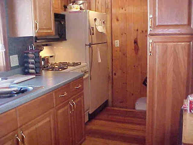 42 Curtin Road Peru, MA 01235 - Photo 2 of 6 a kitchen with a refrigerator stove and cabinets
