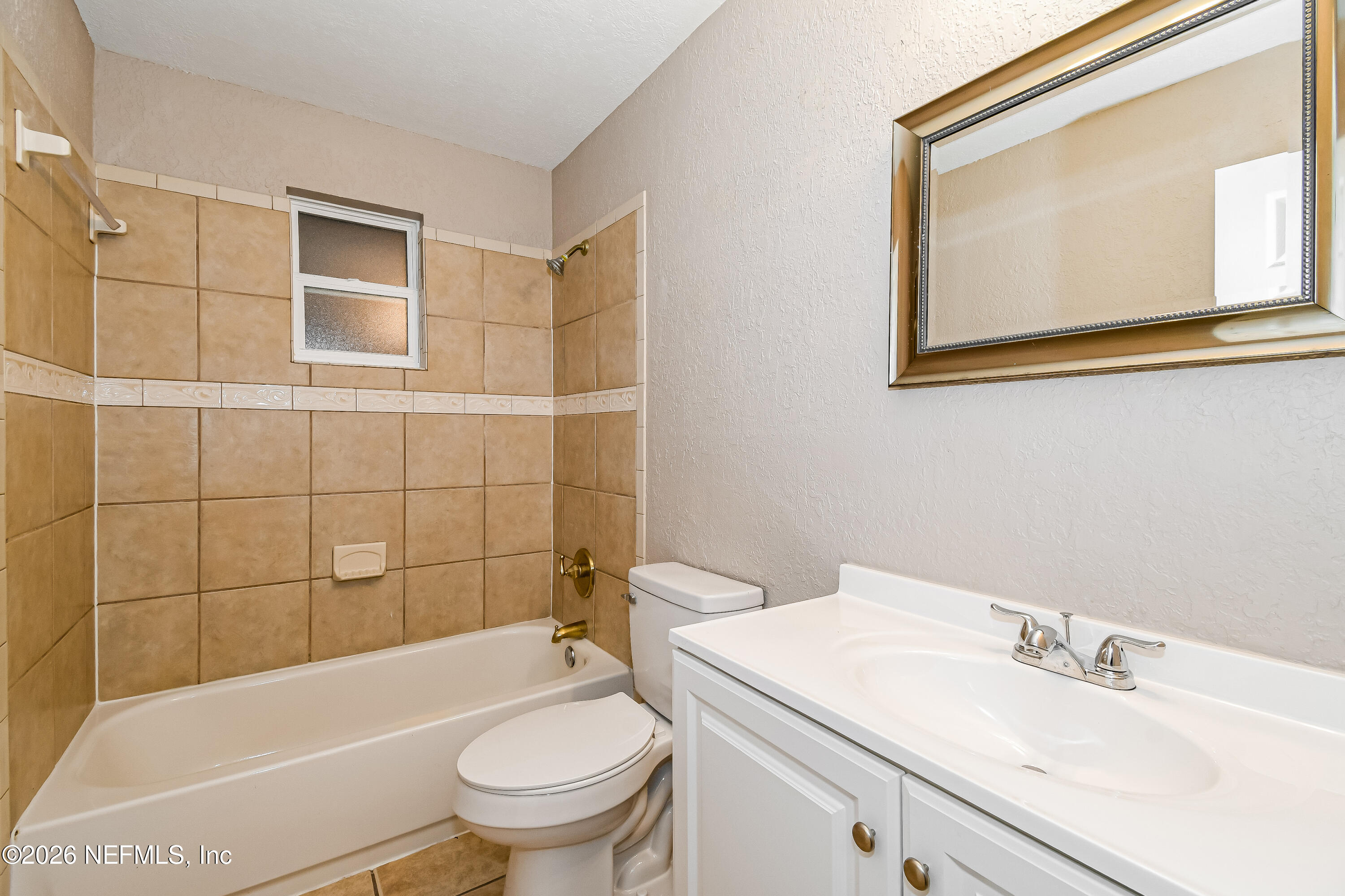 7227 Stonehurst Road North Jacksonville, FL 32277 - Photo 11 of 16 a bathroom with a sink a toilet and shower