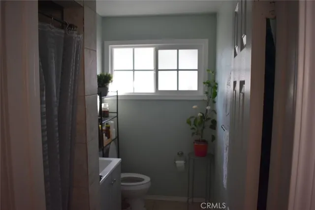 a bathroom with a toilet and a shower