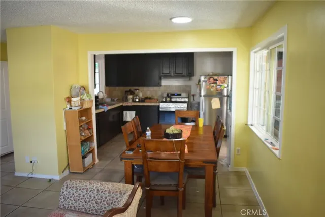 a dining room with furniture and a flat screen tv