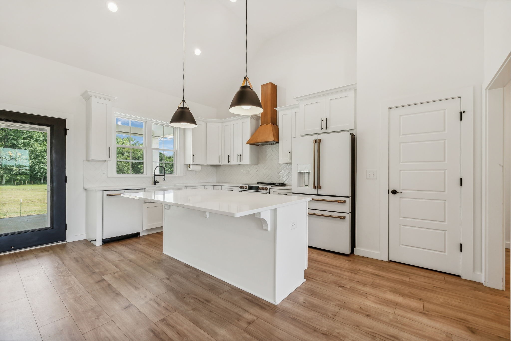 268 Dink Rut Road Portland, TN 37148 - Photo 11 of 62 a kitchen with white cabinets and wooden floor
