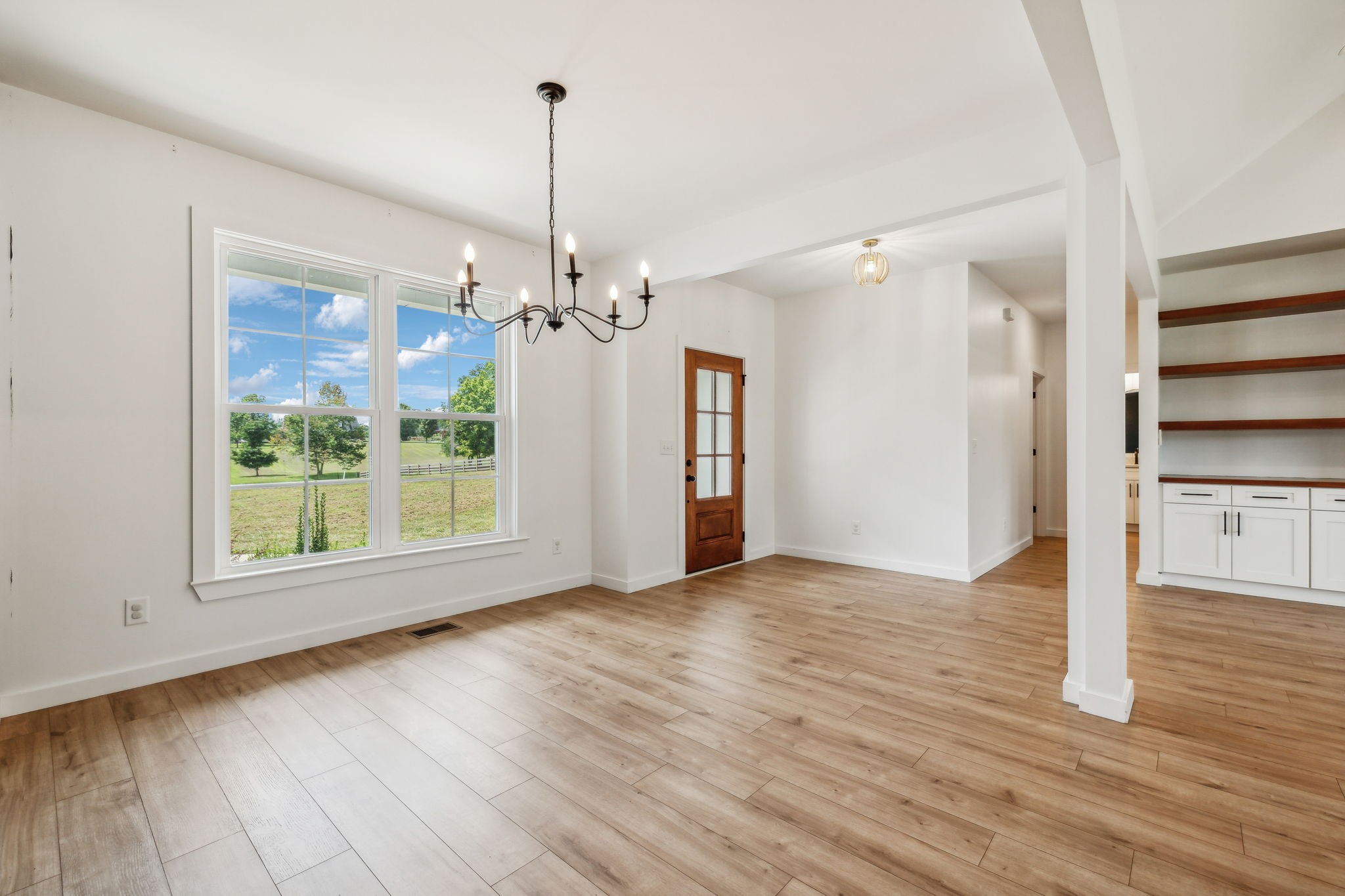 268 Dink Rut Road Portland, TN 37148 - Photo 16 of 62 a view of an empty room with wooden floor kitchen view and a window