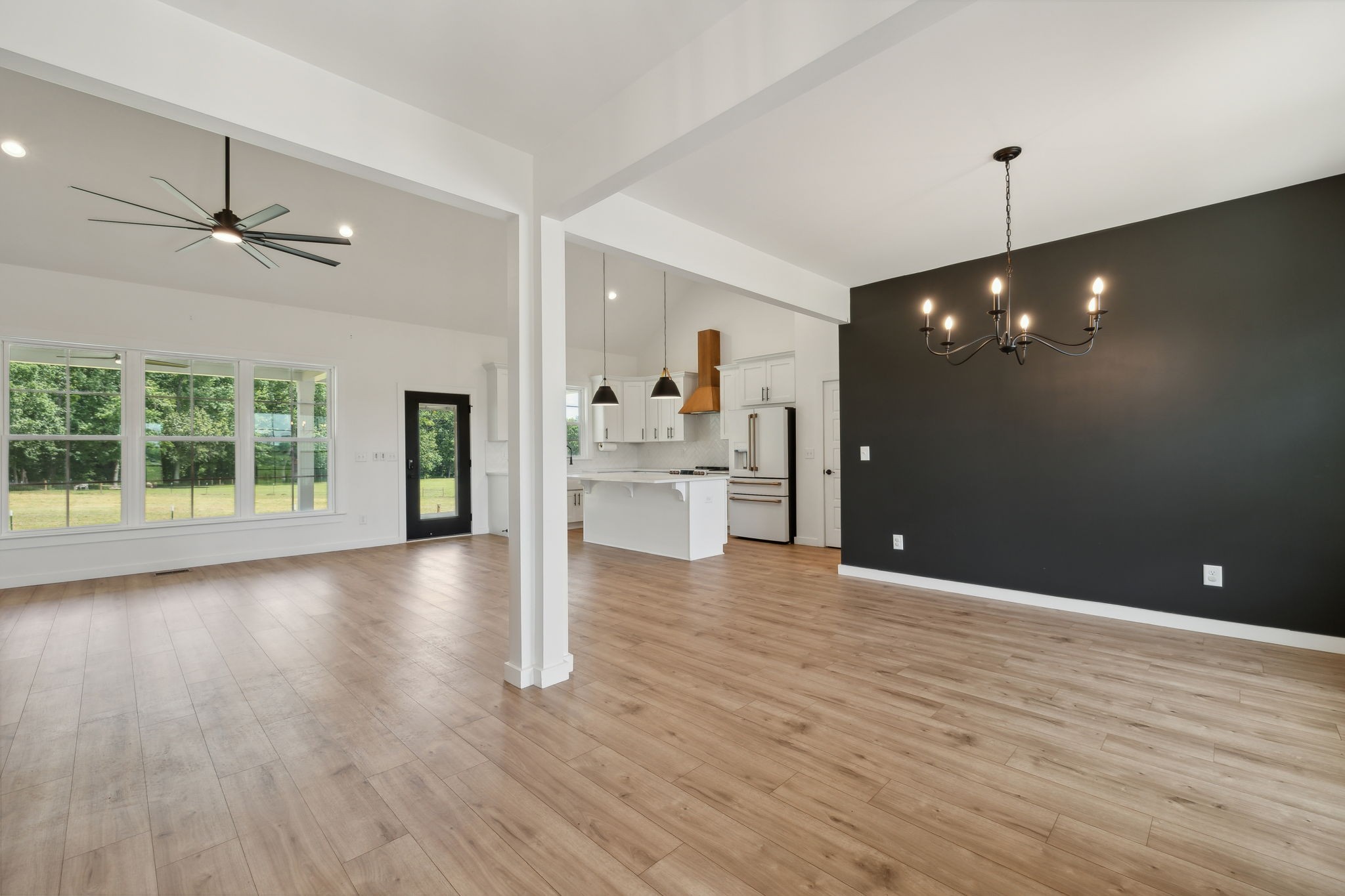 268 Dink Rut Road Portland, TN 37148 - Photo 17 of 62 a view of an empty room with wooden floor and a ceiling fan
