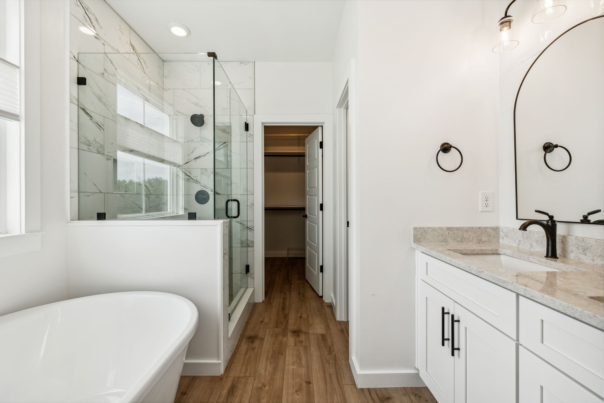 268 Dink Rut Road Portland, TN 37148 - Photo 25 of 62 a bathroom with a granite countertop sink a mirror and a bathtub