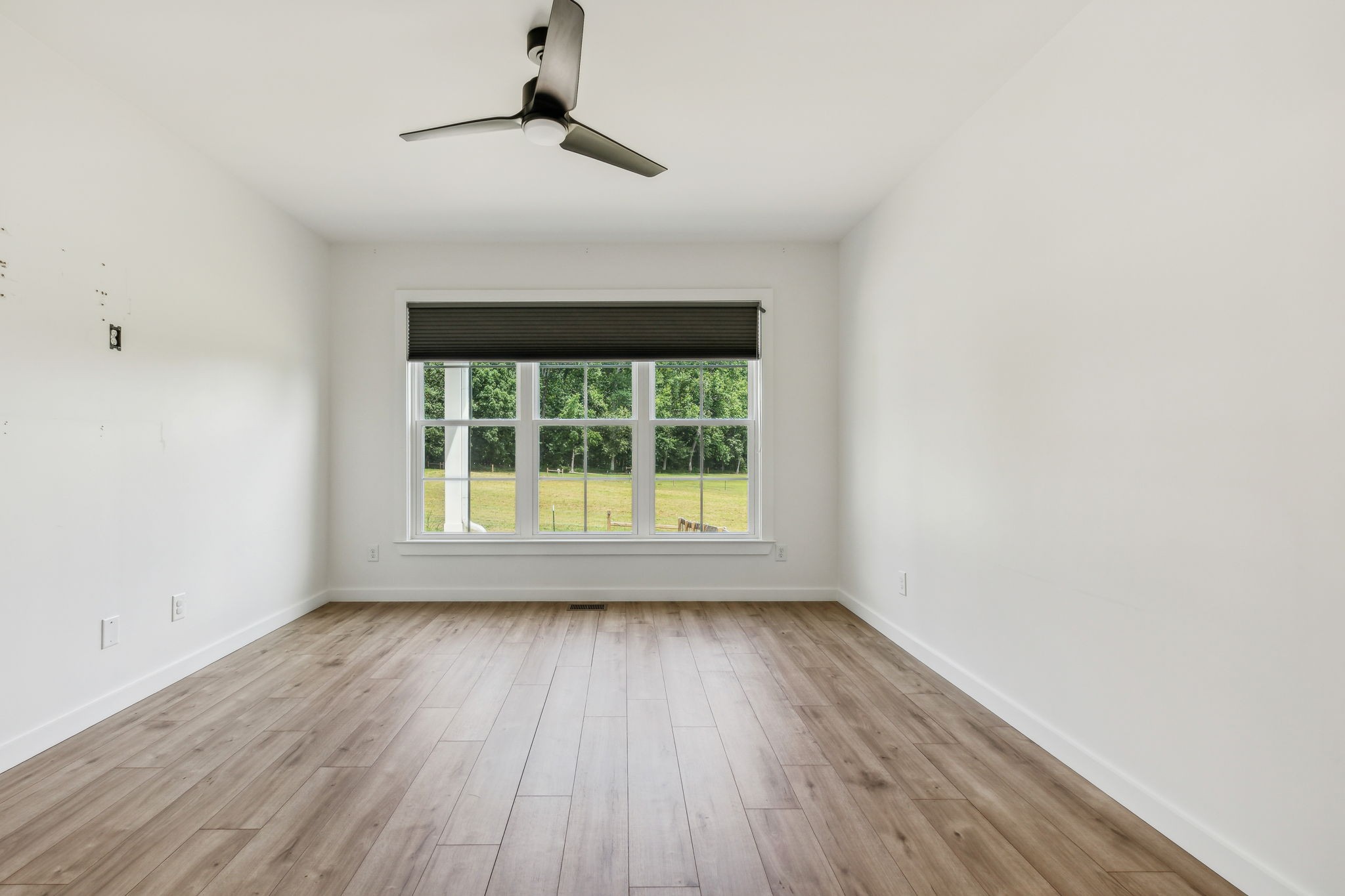 268 Dink Rut Road Portland, TN 37148 - Photo 46 of 62 a view of an empty room with wooden floor and a window