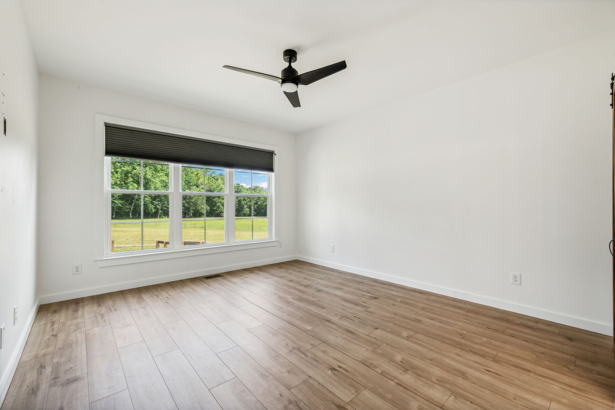 268 Dink Rut Road Portland, TN 37148 - Photo 47 of 62 a view of empty room with wooden floor and fan