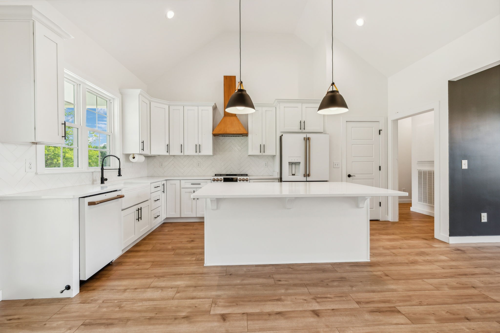 268 Dink Rut Road Portland, TN 37148 - Photo 5 of 62 a large kitchen with stainless steel appliances a large counter top a stove a chimney a sink and a window