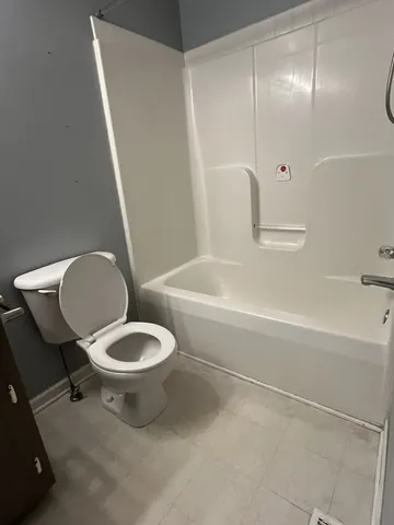 a bathroom with a toilet and a bathtub