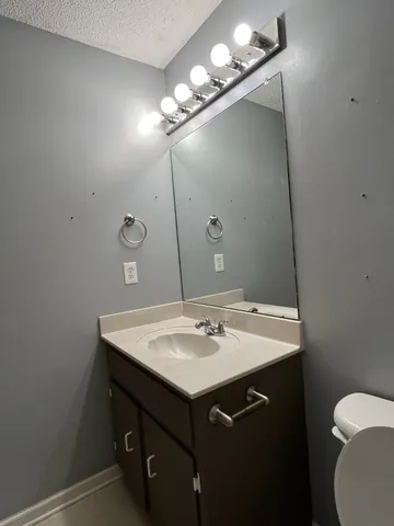 a bathroom with a sink a vanity and a mirror