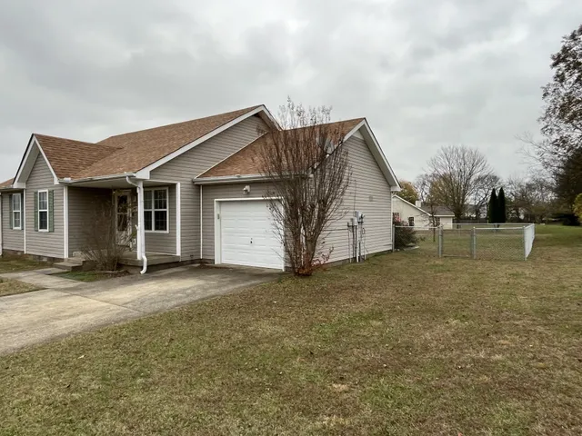 a view of a house with a backyard