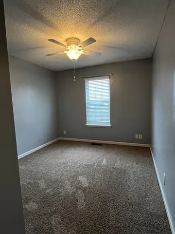 an empty room with a empty space and windows