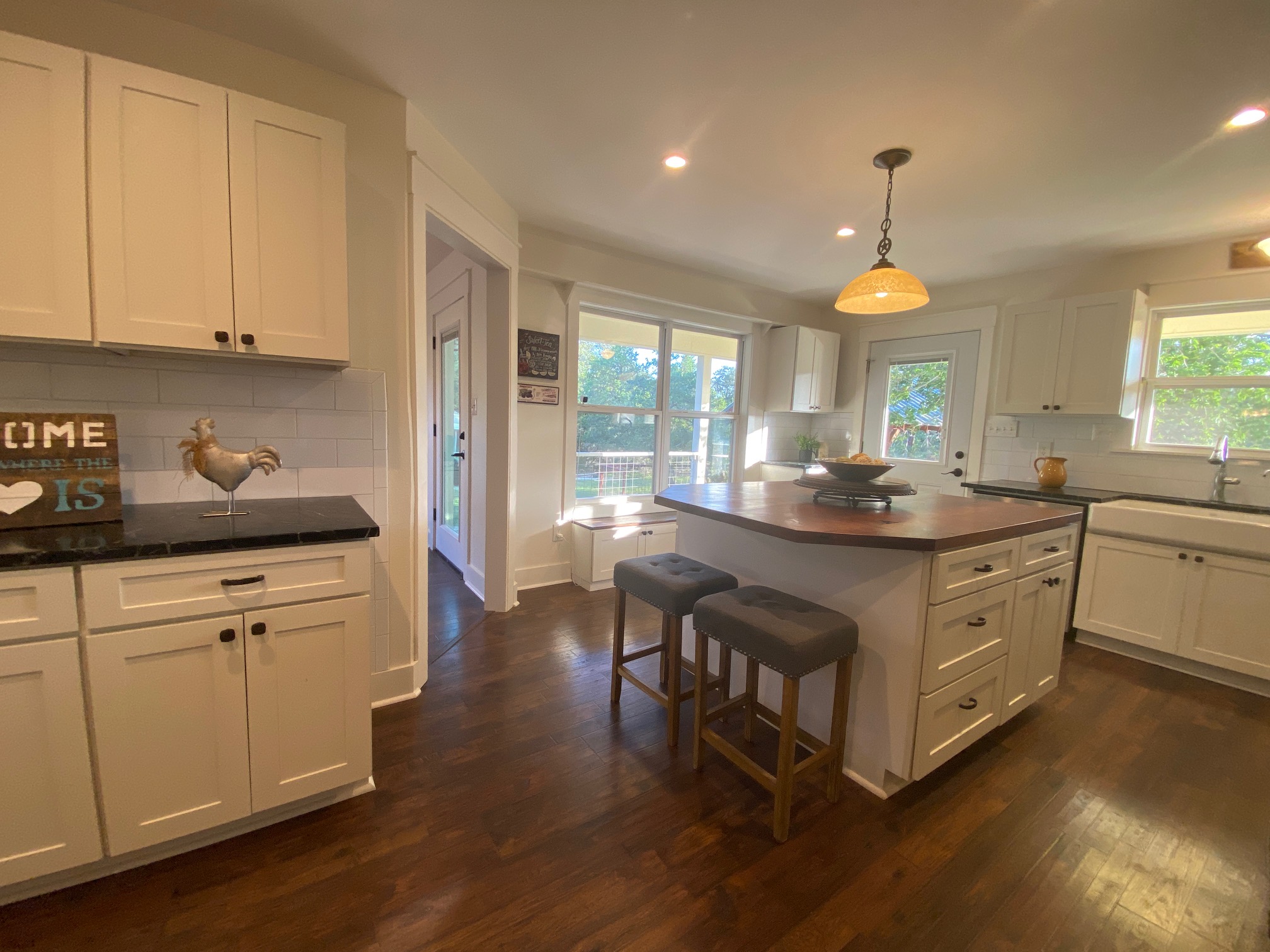 306 Plainview Road Wimberley, TX 78676 - Photo 8 of 29 The Kitchen boasts a spacious island and bright natural light from surrounding windows.