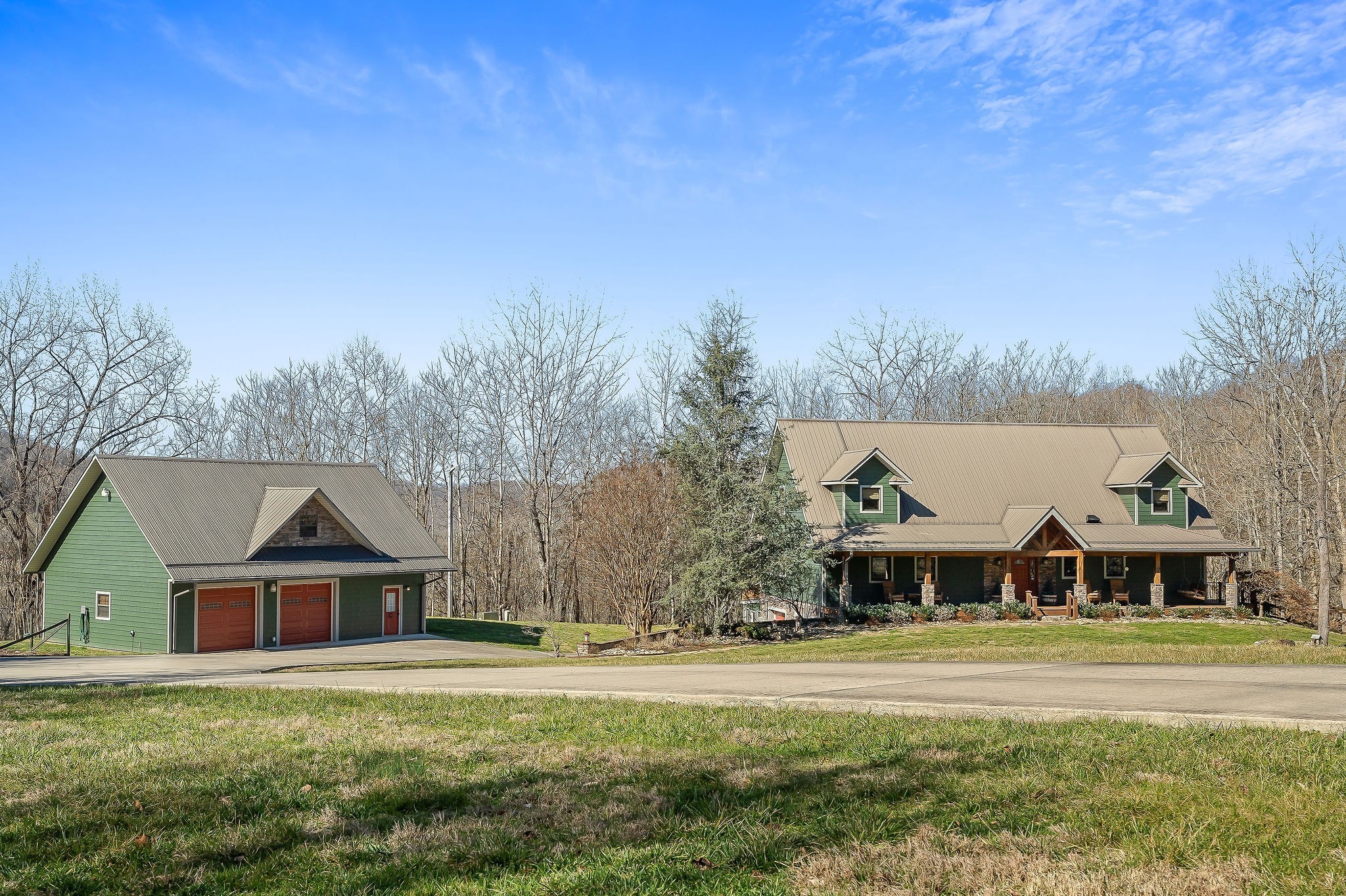 a front view of house with yard and trees in the background