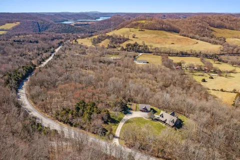 a view of a house with backyard and wooden fence