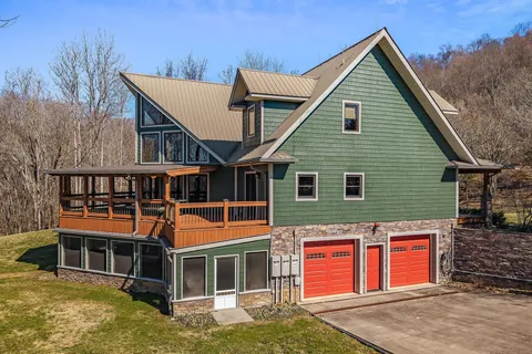 a view of a house with a yard and sitting area