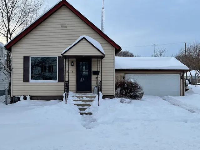 a view of a house with patio and a yard