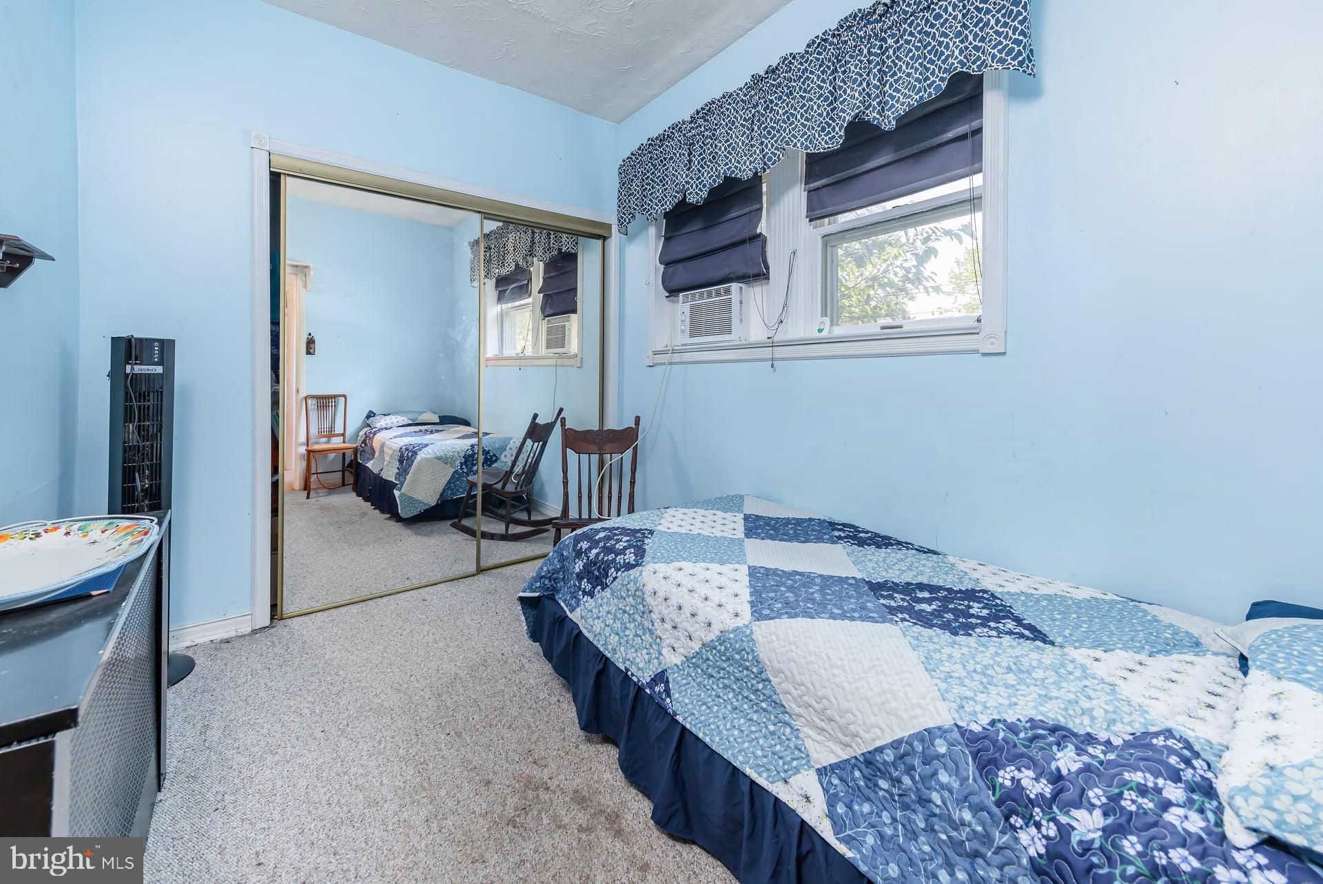 401 West Avenue Delanco, NJ 08075 - Photo 10 of 19 a bed sitting in a bedroom next to a window with two chair