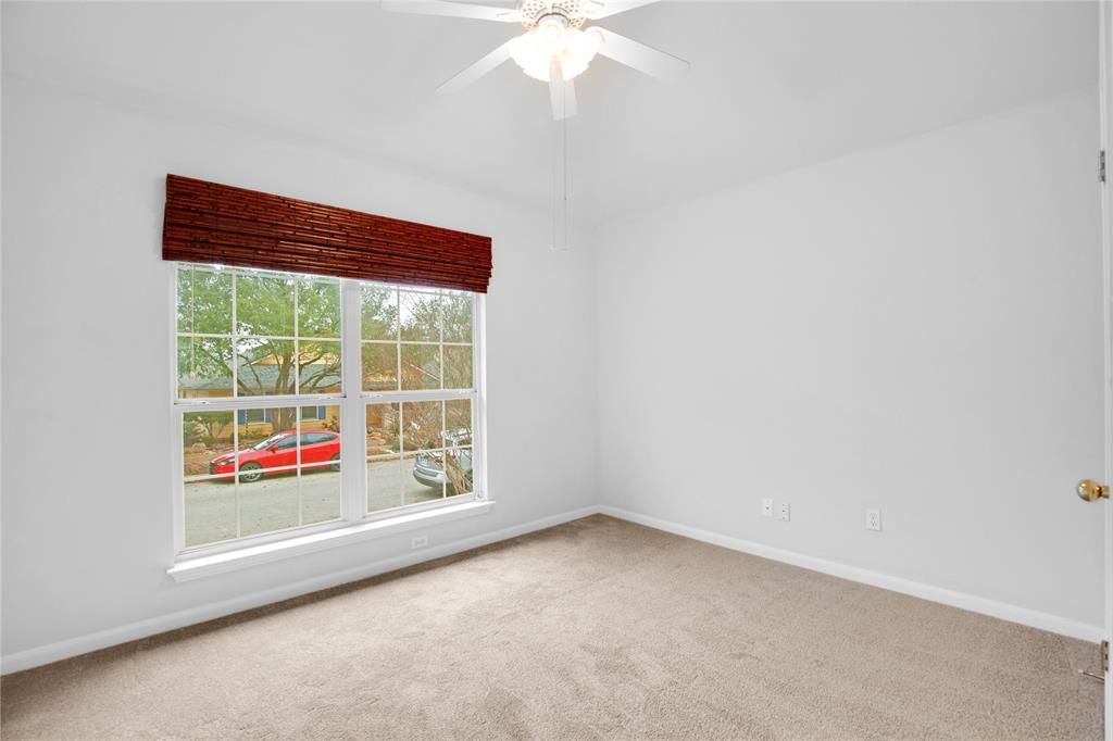 281 Hutton Kyle, TX 78640 - Photo 25 of 37 A well-lit bedroom offering a peaceful retreat, complete with a ceiling fan for comfort.