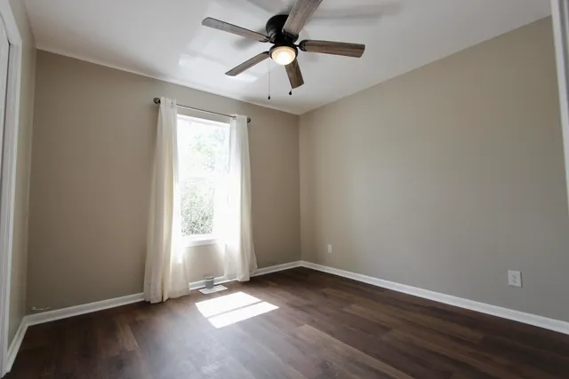 wooden floor in an empty room with a window