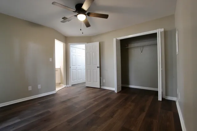 a bathroom with a sink a toilet a mirror and shower