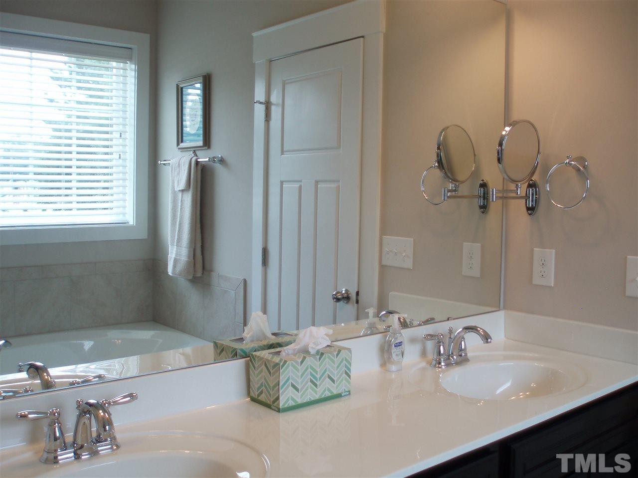 6108 Spring Branch Circle Raleigh, NC 27603 - Photo 11 of 20 a bathroom with a sink and a mirror
