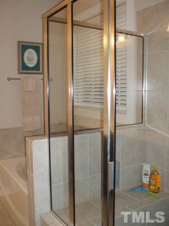 6108 Spring Branch Circle Raleigh, NC 27603 - Photo 12 of 20 a bathroom with a shower and a mirror