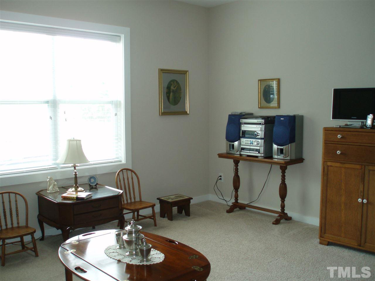 6108 Spring Branch Circle Raleigh, NC 27603 - Photo 15 of 20 a living room with furniture and a flat screen tv
