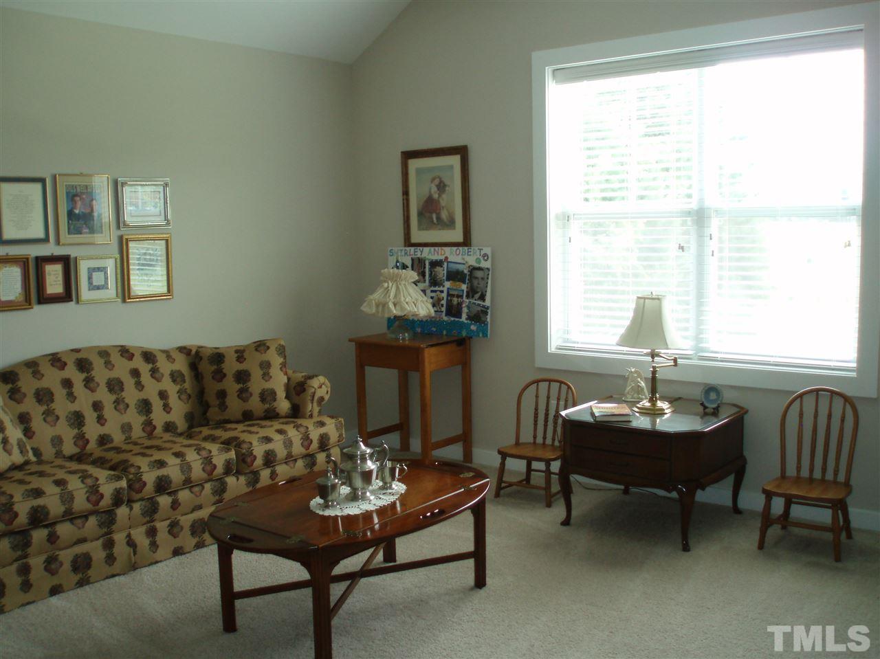 6108 Spring Branch Circle Raleigh, NC 27603 - Photo 16 of 20 a living room with furniture and a window