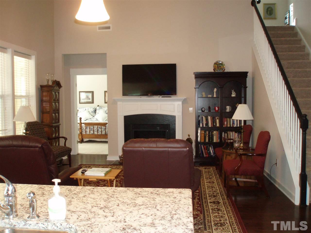 6108 Spring Branch Circle Raleigh, NC 27603 - Photo 6 of 20 a living room with furniture a flat screen tv and a fireplace