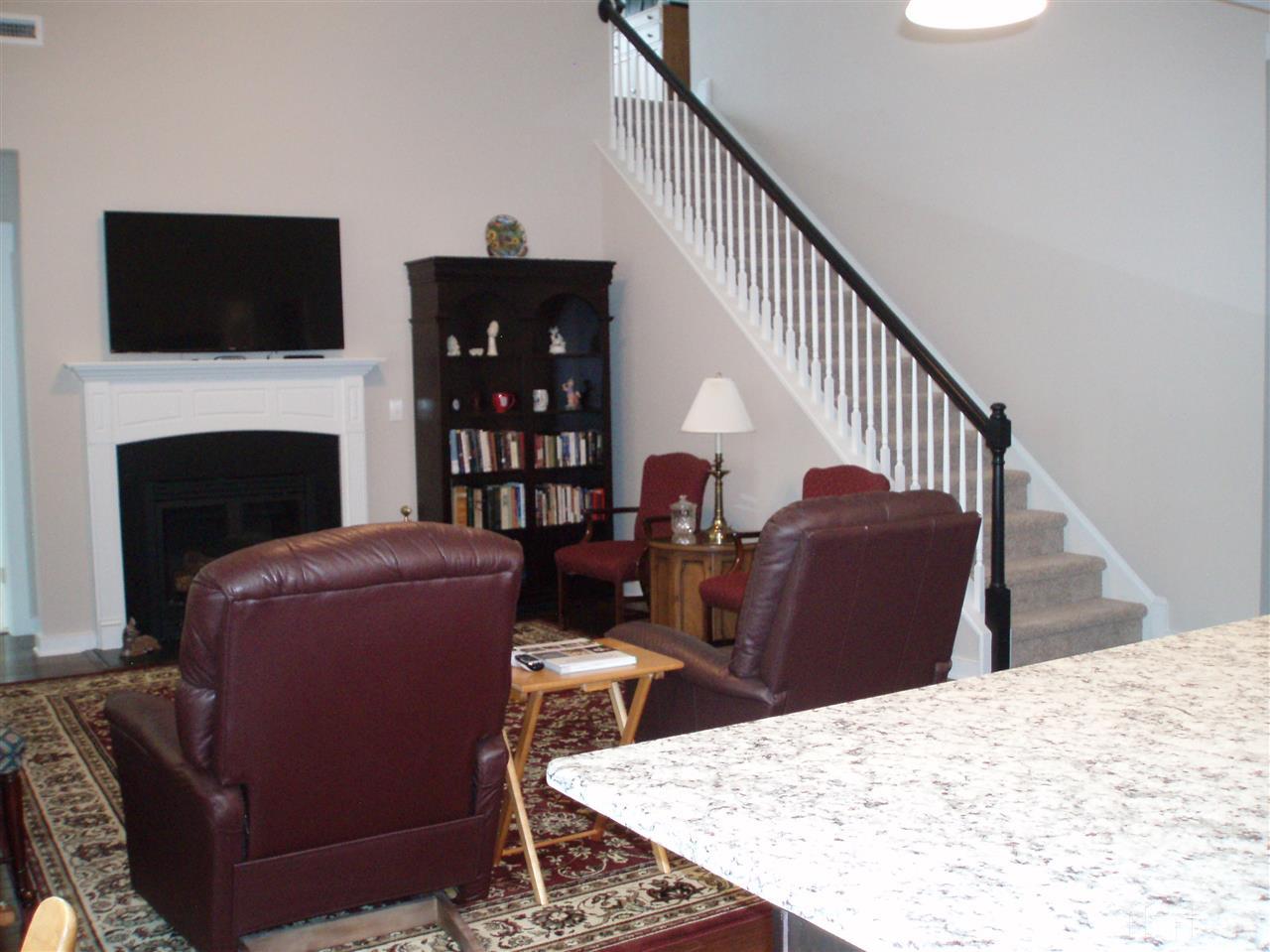 6108 Spring Branch Circle Raleigh, NC 27603 - Photo 8 of 20 a living room with furniture a fireplace and a flat screen tv