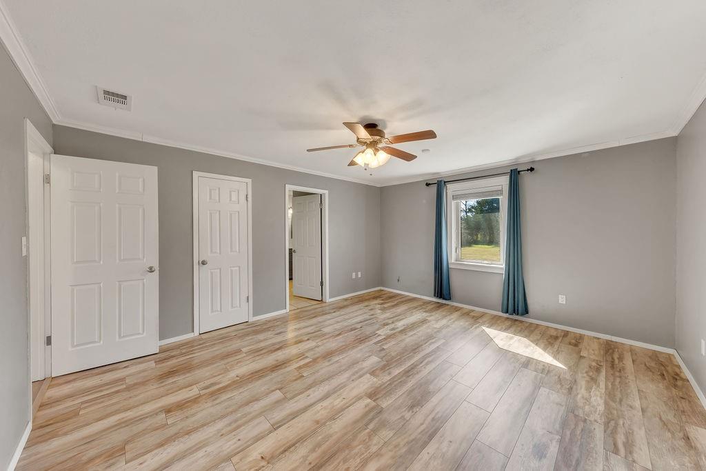 473 County Rd SE 3370 Winnsboro, TX 75494 - Photo 15 of 40 a view of a livingroom with a ceiling fan window and wooden floor