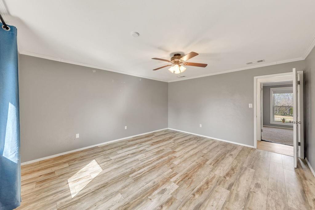 473 County Rd SE 3370 Winnsboro, TX 75494 - Photo 16 of 40 a view of an empty room with wooden floor and a window