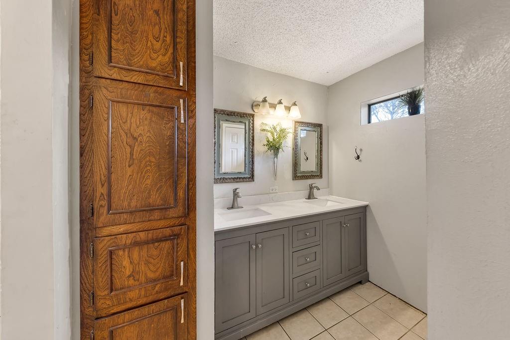 473 County Rd SE 3370 Winnsboro, TX 75494 - Photo 17 of 40 a bathroom with a double vanity sink and mirror
