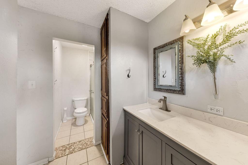 473 County Rd SE 3370 Winnsboro, TX 75494 - Photo 18 of 40 a bathroom with a sink a toilet and a mirror