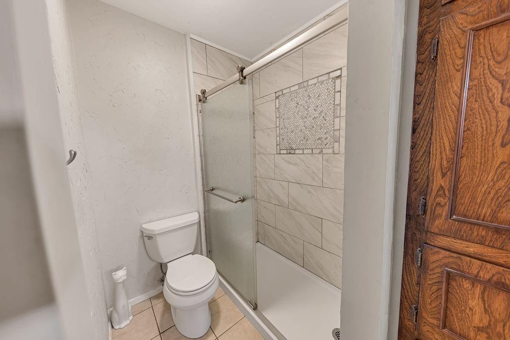 473 County Rd SE 3370 Winnsboro, TX 75494 - Photo 19 of 40 a white toilet sitting next to a shower curtain