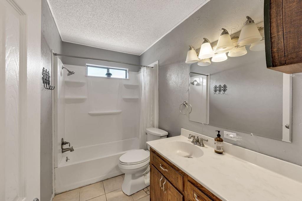 473 County Rd SE 3370 Winnsboro, TX 75494 - Photo 22 of 40 a bathroom with a sink a toilet and a mirror