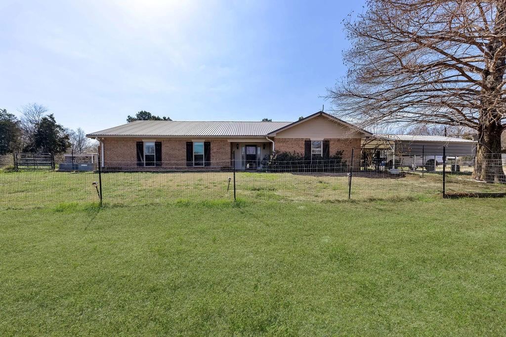 473 County Rd SE 3370 Winnsboro, TX 75494 - Photo 4 of 40 a front view of a house with a yard