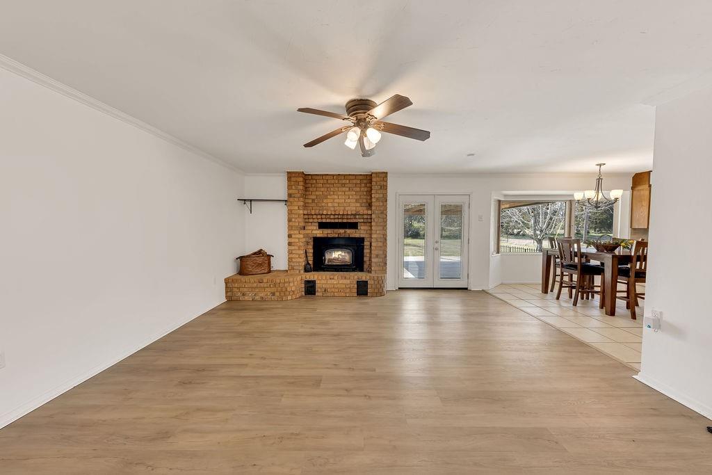 473 County Rd SE 3370 Winnsboro, TX 75494 - Photo 7 of 40 a view of an empty room with furniture and a fireplace